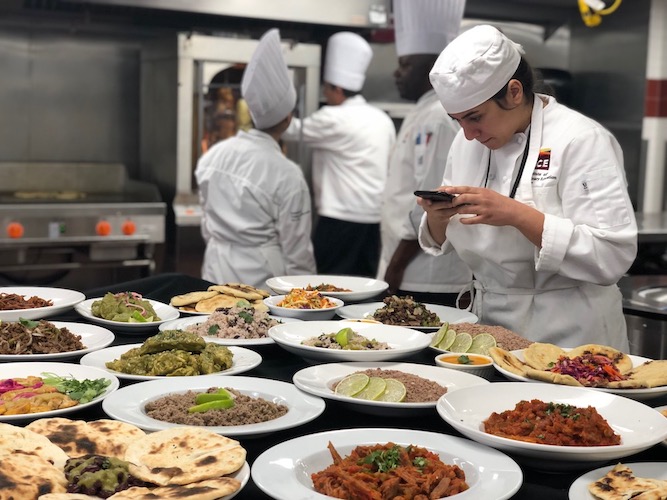 A Culinary school student photographs her class's spread of Latin food at 51茶馆
